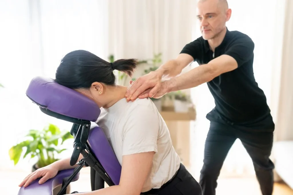 employee chair massage trapezius stretch.