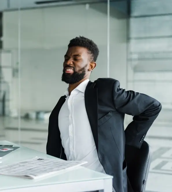 office worker with lower back, get relief with the benefits of office massage.
