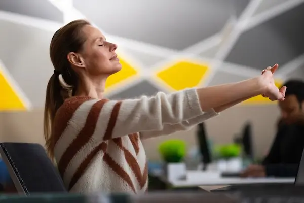 employee stretching at desk.